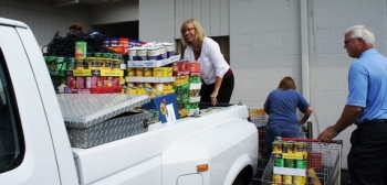 Community Action Committee Senior/Social/Transit Assistant Program Director Pamela Crawford unloads pantry donations from EMâs Portsmouth site employees. | Photos courtesy of the Office of Environmental Management. Community Action Committee Senior/Social/Transit Assistant Program Director Pamela Crawford unloads pantry donations from EMâs Portsmouth site employees. | Photos courtesy of the Office of Environmental Management.