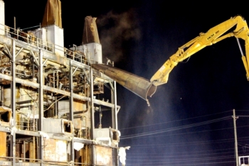 One of three large smoke stacks comes down during the demolition. One of three large smoke stacks comes down during the demolition.