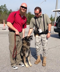 Wade Sumner, Dax's last handler at SRS, says goodbye to Dax as the dog rejoins his former handler, federal Special Agent Patrick Price. Wade Sumner, Dax's last handler at SRS, says goodbye to Dax as the dog rejoins his former handler, federal Special Agent Patrick Price.