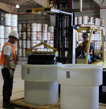 A product drum of mixed low-level waste is lowered into a high-density polyethylene macro-pack. A product drum of mixed low-level waste is lowered into a high-density polyethylene macro-pack.