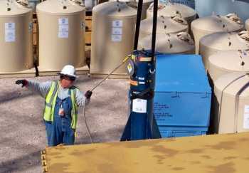 A worker at NNSS handles large, high-powered batteries called radioisotope thermoelectric generators (RTGs), which are discussed in the recent article on the NNSS in RadWaste Solutions magazine. Like most low-level waste, RTGs disposed of at the NNSS were handled without any special equipment or clothing because of the relatively low dose rate levels. A worker at NNSS handles large, high-powered batteries called radioisotope thermoelectric generators (RTGs), which are discussed in the recent article on the NNSS in RadWaste Solutions magazine. Like most low-level waste, RTGs disposed of at the NNSS were handled without any special equipment or clothing because of the relatively low dose rate levels.