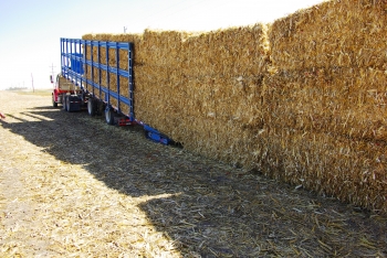 The self-loading trailer can automatically load or unload these large packs of bales -- made of biomass feedstocks -- in less than 15 minutes, reducing time and additional equipment needed to distribute the material to a biorefinery. | Photo courtesy of Antares Group. The self-loading trailer can automatically load or unload these large packs of bales -- made of biomass feedstocks -- in less than 15 minutes, reducing time and additional equipment needed to distribute the material to a biorefinery. | Photo courtesy of Antares Group.