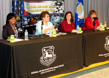 Dot Harris, Director of the Office of Economic Impact and Diversity, speaks with Aurea Rivera, President and CEO of Imagineering Results Analysis Corp., Kathleen Tucker, Director of the Information Exploitation Squadron, Global Exploitation Intelligence Group, NAISC, and Ann Carbonell, Chief of the National Geospatial Intelligence Agency Support Team in September 2013. Photo by National Air and Space Intelligence Center. Dot Harris, Director of the Office of Economic Impact and Diversity, speaks with Aurea Rivera, President and CEO of Imagineering Results Analysis Corp., Kathleen Tucker, Director of the Information Exploitation Squadron, Global Exploitation Intelligence Group, NAISC, and Ann Carbonell, Chief of the National Geospatial Intelligence Agency Support Team in September 2013. Photo by National Air and Space Intelligence Center.