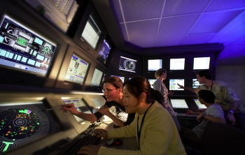Stanford Physics Professor Pat Burchat and student Ho Jeong Kim in the BaBar main control room at the SLAC National Lab. | Photo courtesy of the SLAC National Accelerator Lab. Stanford Physics Professor Pat Burchat and student Ho Jeong Kim in the BaBar main control room at the SLAC National Lab. | Photo courtesy of the SLAC National Accelerator Lab.