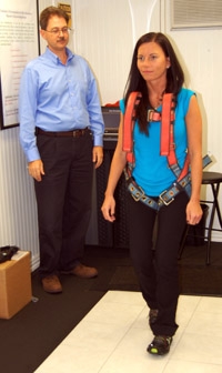 A Savannah River Remediation employee finds out how hazardous slippery conditions can be as part of a safety demonstration inside the URS Slip Simulator. A harness connected to a support beam allows participants to experience walking on slippery conditions without falling. | Photo by Energy Department A Savannah River Remediation employee finds out how hazardous slippery conditions can be as part of a safety demonstration inside the URS Slip Simulator. A harness connected to a support beam allows participants to experience walking on slippery conditions without falling. | Photo by Energy Department