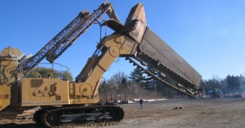 This 2009 photo shows a trenching machine, which is capable of cutting a continuous trench up to 30 feet deep and 3 feet wide. The machine was used in a pilot study to evaluate the effectiveness of zeolite placement as the trench was dug. This ensured a consistent depth and width for the zeolite placement along the entire length of the permeable treatment wall. This 2009 photo shows a trenching machine, which is capable of cutting a continuous trench up to 30 feet deep and 3 feet wide. The machine was used in a pilot study to evaluate the effectiveness of zeolite placement as the trench was dug. This ensured a consistent depth and width for the zeolite placement along the entire length of the permeable treatment wall.