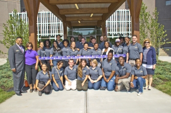 Students celebrate the ribbon cutting at their energy efficient housing center. | Photo courtesy of the University at Albany. Students celebrate the ribbon cutting at their energy efficient housing center. | Photo courtesy of the University at Albany.