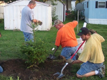 Volunteers from the Waverly Trees Forever group are planting windbreak trees on the north side of the mobile home court. Waverly experienced record flooding in 2008. | Photo Courtesy of Trees Forever Volunteers from the Waverly Trees Forever group are planting windbreak trees on the north side of the mobile home court. Waverly experienced record flooding in 2008. | Photo Courtesy of Trees Forever