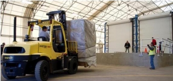 A worker transports the first box of waste to be repackaged at the 375 box line facility. A worker transports the first box of waste to be repackaged at the 375 box line facility.