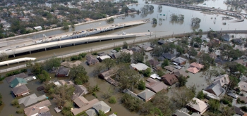 This aerial photo of New Orleans from August 29, 2005, shows a flooded neighborhood with a roadway going down into flood waters. Photo Courtesy of FEMA/Jocelyn Augustino This aerial photo of New Orleans from August 29, 2005, shows a flooded neighborhood with a roadway going down into flood waters. Photo Courtesy of FEMA/Jocelyn Augustino