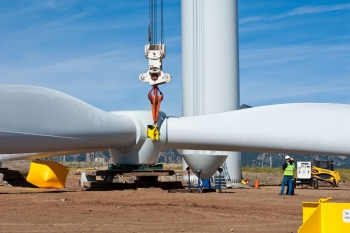 Workers use a giant crane to lift the blade assembly on a wind turbine at NREL's National Wind Technology Center. | Photo by Dennis Schroeder. Workers use a giant crane to lift the blade assembly on a wind turbine at NREL's National Wind Technology Center. | Photo by Dennis Schroeder.