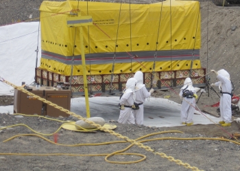 A box of transuranic waste is removed from an underground storage trench at the Hanford Site A box of transuranic waste is removed from an underground storage trench at the Hanford Site