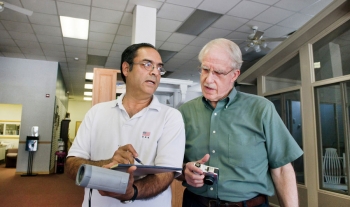 Discussing energy audit results â Dr. Bhaskaran Gopalakrishnan (left) and Dr. Ed Crowe (right, Engineering Scientist at West Virginia University) discuss some of the findings of an energy audit of a small business in Fairmont.<br/><em>WVU, Photo by Brian Persinger</em> Discussing energy audit results â Dr. Bhaskaran Gopalakrishnan (left) and Dr. Ed Crowe (right, Engineering Scientist at West Virginia University) discuss some of the findings of an energy audit of a small business in Fairmont.<br/><em>WVU, Photo by Brian Persinger</em>