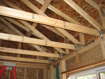 Planning carefully for insulation results in reduced utility bills and superior comfort during the life of the home. In this house, raised heel trusses accommodate R-60 insulation. | Credit: Paul Norton, NREL.
Planning carefully for insulation results in reduced utility bills and superior comfort during the life of the home. In this house, raised heel trusses accommodate R-60 insulation. | Credit: Paul Norton, NREL.