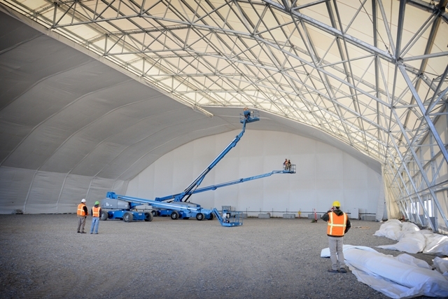 Workers install fabric inside the Accelerated Retrieval Project IV retrieval enclosure. Retrieval enclosures are designed to withstand sunlight, snow and wind and maintain a negative pressure inside Workers install fabric inside the Accelerated Retrieval Project IV retrieval enclosure. Retrieval enclosures are designed to withstand sunlight, snow and wind and maintain a negative pressure inside