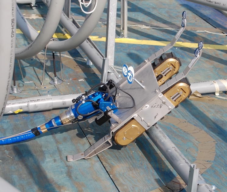 A robotic device named Tizzy was retrofitted by Savannah River Remediation (SRR) employees to collect and remove tank waste. Using $100,000 from the Recovery Act, SRR designed and built Tizzy. Here the robot is being tested on a mock-up of a waste tank