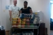 Barry Gaffney and Evette Dillon with EM's Office of Program Planning and Budget stand behind a portion of the office's donations to Feds Feed Families.