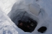 Researcher Joel Bailey measures the density of the snow in this snow pit to determine the amount of snow in the drift and the water equivalent of the snow drift.