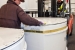 Workers move standard waste boxes to the High-Energy Real Time Radiography facility.
