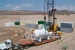 Waste management specialists disposed approximately 1.8 million cubic feet of low-level and mixed low-level radioactive waste at the Area 5 Radioactive Waste Management Site, which amounts to 2,558 shipments and 13,173 packages of waste. These volumes constitute approximately 5 percent of the low-level and mixed low-level waste generated throughout DOE complex. This photo shows Area 5 waste disposal operations