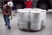Operators prepare drums of contact-handled transuranic waste for loading into transportation containers