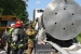 A firefighter trained to respond to radiological events performs a radiological survey of the WIPP shipping package as part of a WIPP transportation exercise in Morgan County, Georgia.