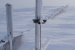 Monitoring equipment and part of the snowfence peek out of the snow drift.
