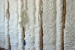Icynene plastic insulation blown into the walls of a home near Denver. Icynene fills cracks and crevices and adheres to the framing. | Photo courtesy of Paul Norton, NREL.