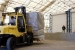 A worker transports the first box of waste to be repackaged at the 375 box line facility.