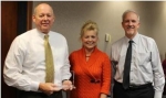 EMCBC Director Jack Craig, left to right, EM Executive Assistant Jillian Carter, who is EM's Feds Feed Families representative, and Senior Advisor for Environmental Management David Huizenga pause for a photo Nov. 8. Craig holds the "Teamwork Award" he and his staff received.