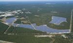 An aerial view of the 32-megawatt photovoltaic array of the Long Island Solar Farm, which will produce enough energy to power up to 4,500 local homes. The central Brookhaven National Laboratory campus is seen at left.