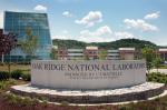 Oak Ridge National Laboratory’s main entrance is marked by a limestone sign. Several new buildings visible in the background house more than 1,000 of the lab’s 4,300 employees. | Photo courtesy of Oak Ridge National Laboratory