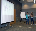 NSSAB student liaisons Gumabon, left, and Leavitt discuss their project involving a student survey and educational tool to members of the NSSAB.