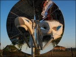 The new hybrid solar-natural gas system from Pacific Northwest National Laboratory (PNNL) works through concentrating solar power, which uses a reflecting surface to concentrate the sun's rays like a magnifying glass. In the case of the new system from PNNL, a mirrored parabolic dish directs sunbeams to a central point, where a device absorbs the solar heat to make syngas.| Photo courtesy of PNNL. 