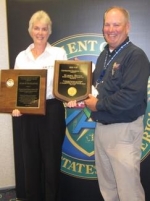 Wastren-EnergX Mission Support (WEMS) Senior Safety Engineer Marsha Bevins, left, stands with DOE Director of Worker Safety and Health Brad Davy while holding her Voluntary Protection Program Contractor Champion of the Year award and the 2012 Star of Excellence award WEMS received.