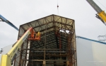 Workers construct an enclosure for Building H2 at the Separations Process Research Unit