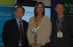 Secretary Steven Chu with Kellie Walsh and Cris Dorman of Greater Indiana Clean Cities at the Green Truck Summit in Indianapolis, IN, in front of a display describing the coalition's Recovery Act-supported project. | Photo by Trish Cozart, NREL.