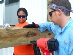 James Cunningham, right, nails a board to the framework for a deck project in Jackson. Ashley Flowers, Savannah River Remediation project controls intern, assists by holding the board in place.