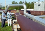 Harrel McCray, left, and Joey Clark, employees with SRS management and operations
contractor, Savannah River Nuclear Solutions, stand by an extensive SRS cleanup system that
safely and successfully rid the site of more than 33,000 gallons of non-radioactive chemical
solvents from 10 million cubic feet of soil through the injection of millions of pounds of steam.