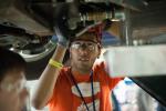 A North Carolina State University student works on an EcoCAR vehicle at the Year 3 finals last year in Milford, MI. | Energy Department photo. 
