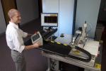Application Engineer Eric Biedermann of Vibrant supervises an automated nondestructive testing system. | Photo courtesy of Sandia National Lab.