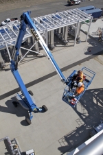 Workers use a lift to access part of the 200 West Groundwater Treatment Facility.