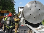 A firefighter trained to respond to radiological events performs a radiological survey of the WIPP shipping package as part of a WIPP transportation exercise in Morgan County, Georgia.