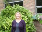 An Energy Department grant funded Autumn Salamack's new job as resource conservation manager for Kitsap County, Washington, and the energy efficient windows framed behind her. | Photo courtesy of Kitsap County, WA |