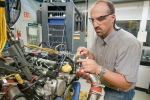 Argonne engineer Steve Ciatti works on an engine in Argonne's Engine Research Facility -- a facility where researchers can study in-cylinder combustion and emissions under realistic operating conditions. | Photo courtesy of Argonne National Laboratory.