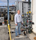 Chromium Water Treatment System Facility Manager Matt Finley stands near one of the facility’s ground wells.