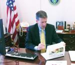 Michael W. Locatis, CIO, Department of Energy, reviews report on Identity Management Program