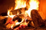 Burning firewood can keep you warm and cozy while keeping your thermostat and electricity use low. | Photo courtesy of ©iStockphoto.com/Pgiam.