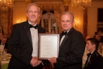 EM Senior Advisor Dave Huizenga, left, receives the Presidential Rank of Distinguished Executive award from Eric Coulter, treasurer of the board of directors for the Senior Executives Association, which sponsors the awards program.
