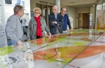 Steve Hampson of the University of Kentucky, left to right, West Kentucky Community & Technical College President Dr. Barbara Veazey, Paducah Junior College Board of Trustees member Ken Wheeler and Buz Smith of the DOE Paducah Site Office examine a DOE Paducah Site groundwater model exhibit at the West Kentucky Community & Technical College Emerging Technology Center.